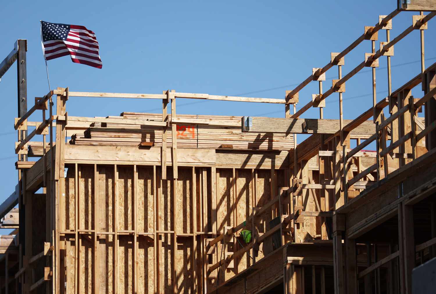 An American flag flies above the construction site of a multifamily housing development on June 02, 2023 in Los Angeles, California.