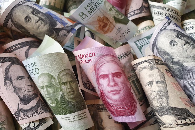 A close up of rolled up United States currency and Mexician Pesos spred on a surface