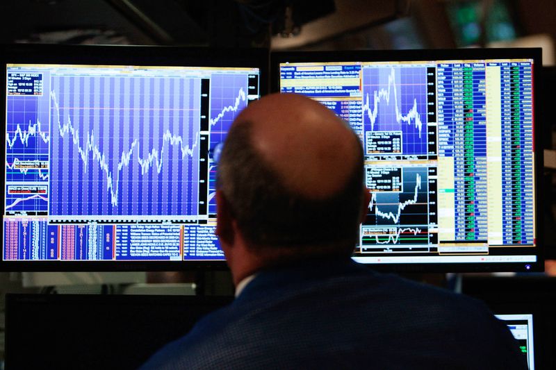  A financial professional loosk at his computer screen on the floor of the New York Stock Exchange at the end of the trading day