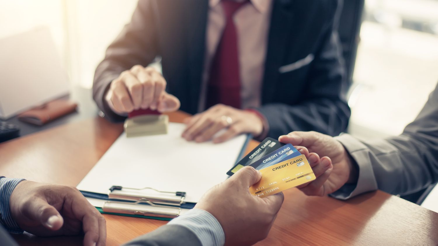 Two people exchanging credit cards