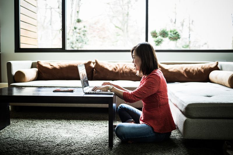 Woman using a laptop at home