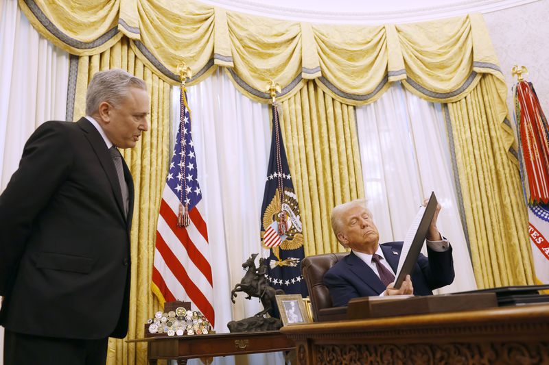 David Sacks, U.S. President Donald Trump's "AI and Crypto Czar", speaks to President Trump as he signs a series of executive orders in the Oval Office of the White House on January 23, 2025 in Washington, DC. 