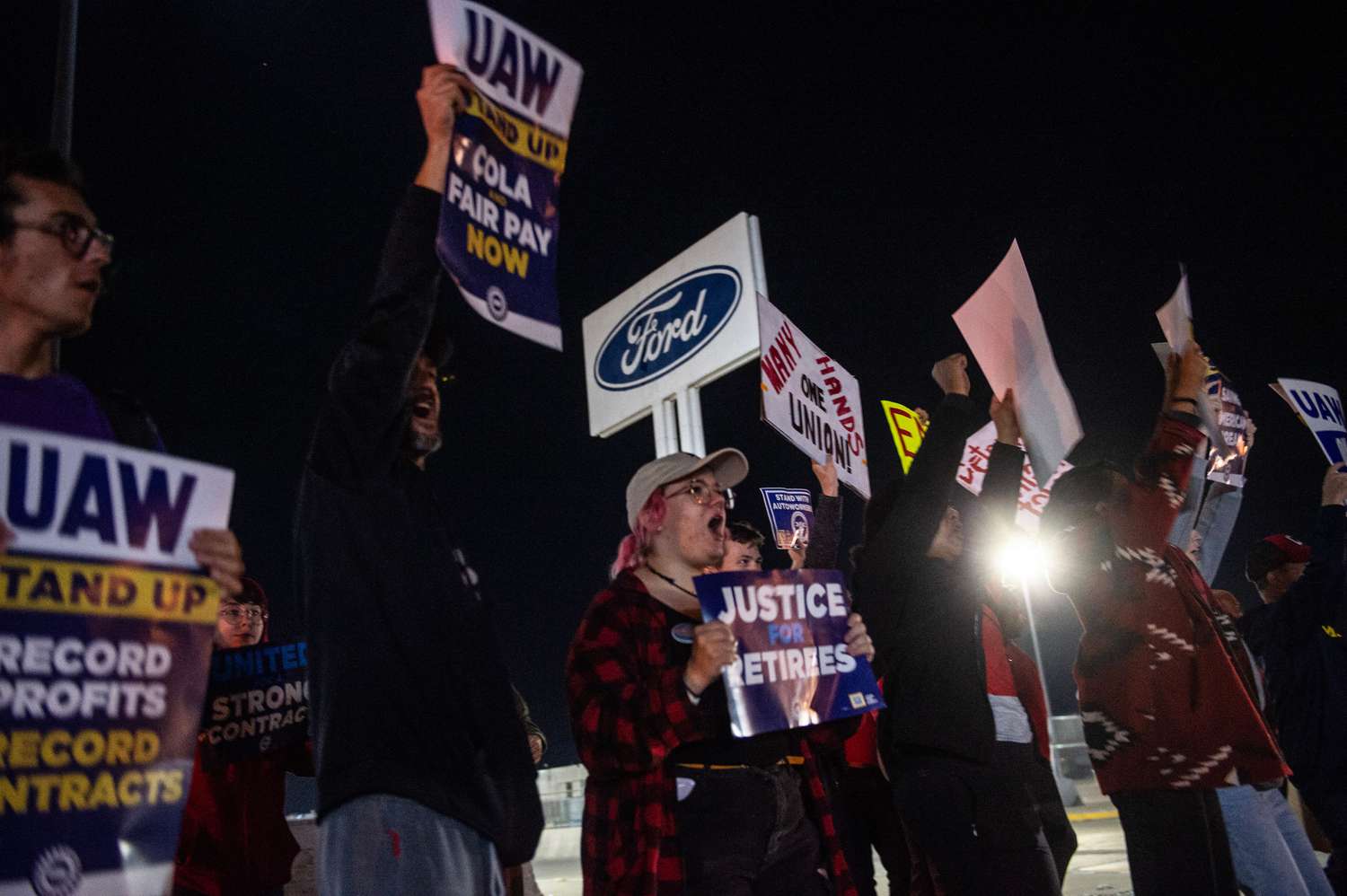 United Auto Workers members picket outside a Ford assembly plant.