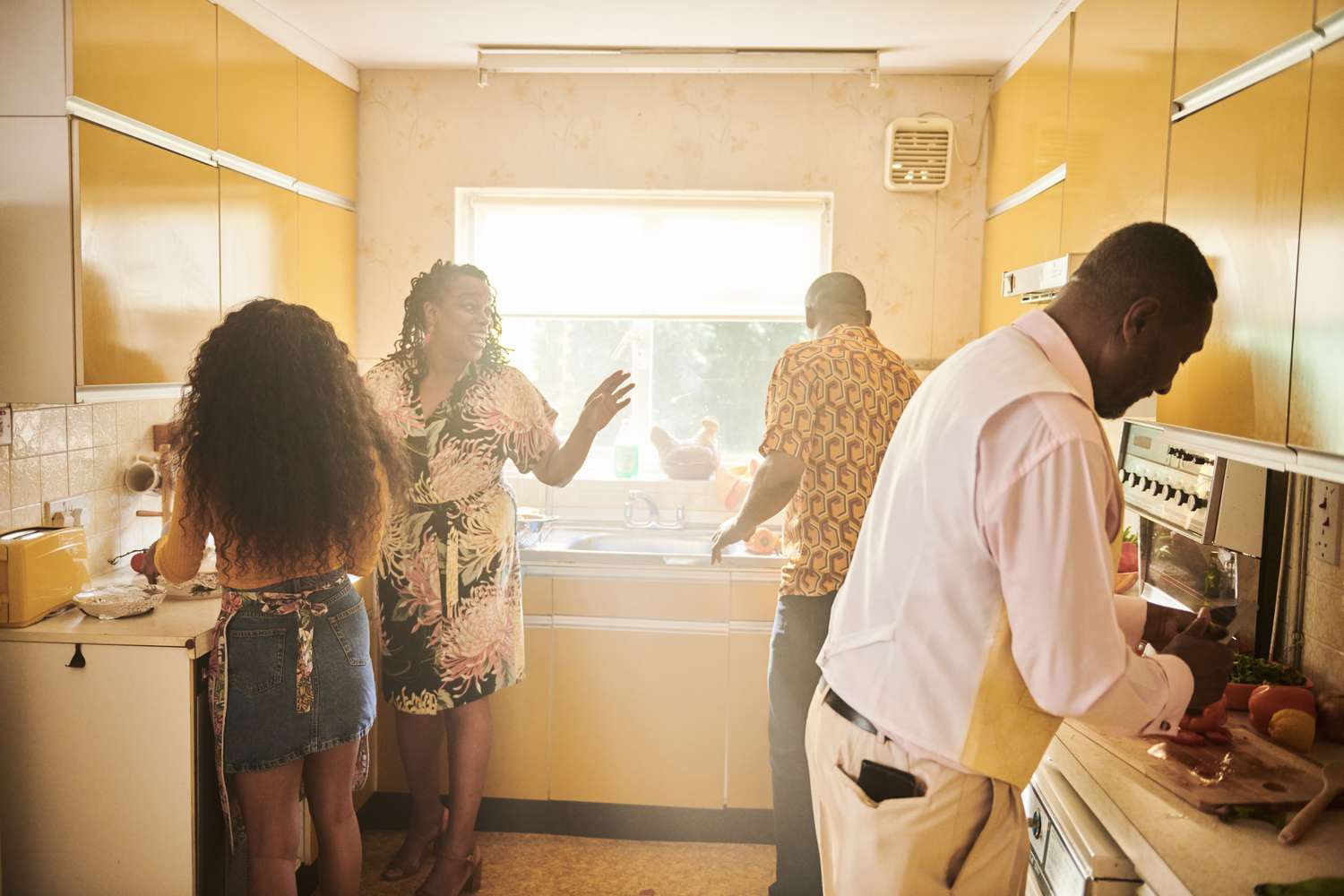 A multigeneration family preparing a meal in a kitchen