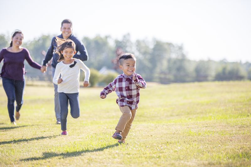 A family running through a field together.