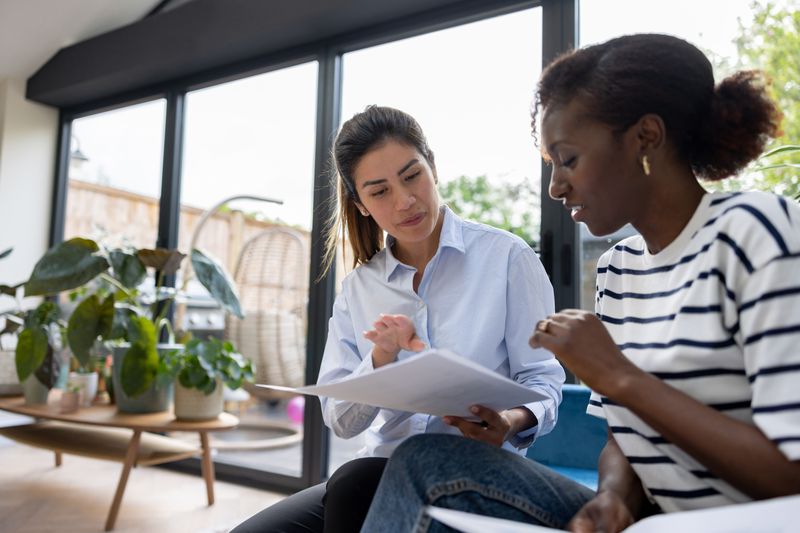African American woman talking to a financial advisor about selling her house with Home Equity Loan