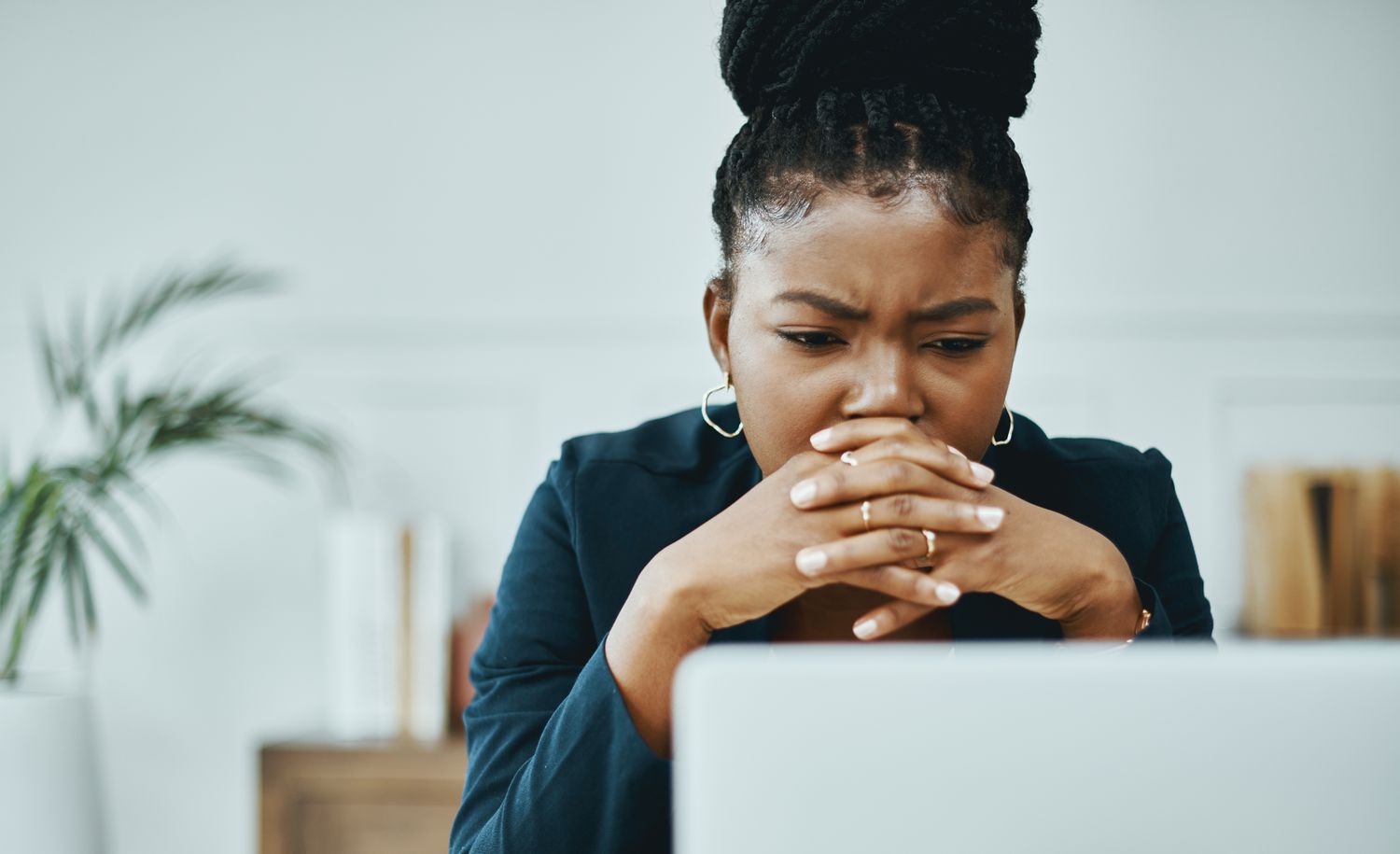 A concerned woman looking at a computer