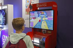 A gamer plays a video game on a Nintendo Switch game console.