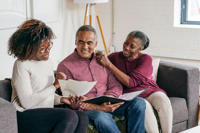 insurance agent speaking with elderly couple