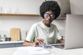 A worker with a computer and a phone