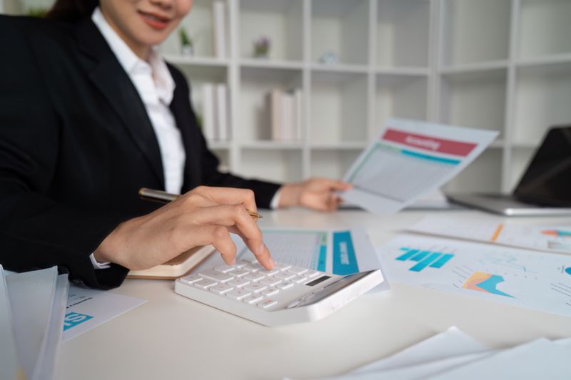 A woman with a calculator and papers
