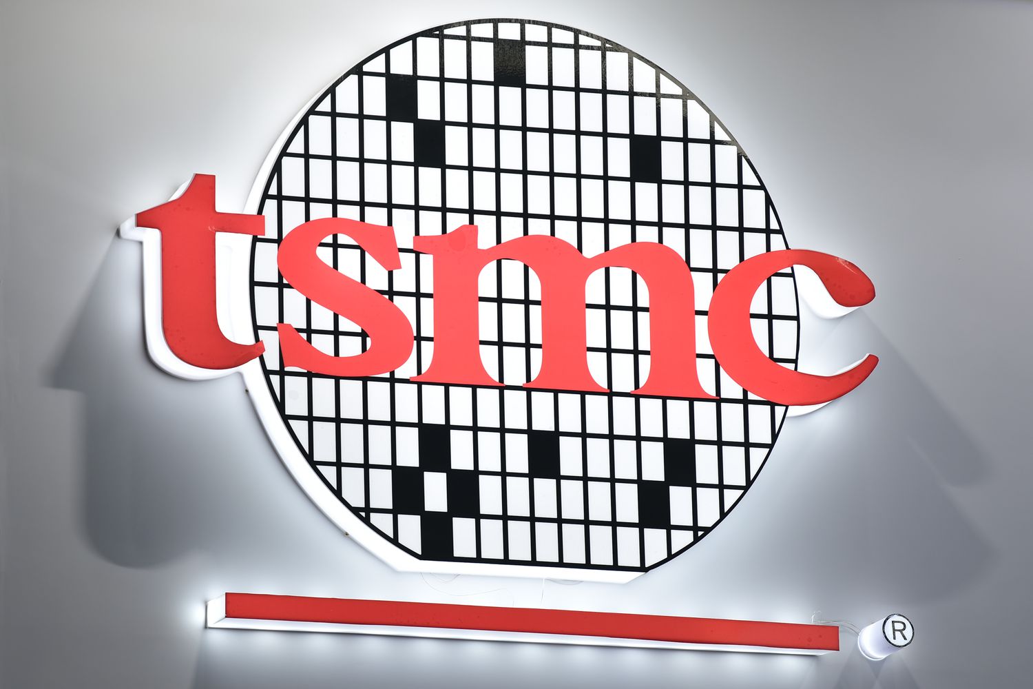 A sign with the Taiwan Semiconductor Manufacturing Company logo at an industry event.