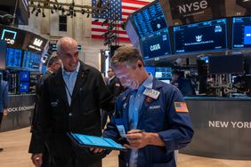 Two traders on the floor of the New York Stock Exchange