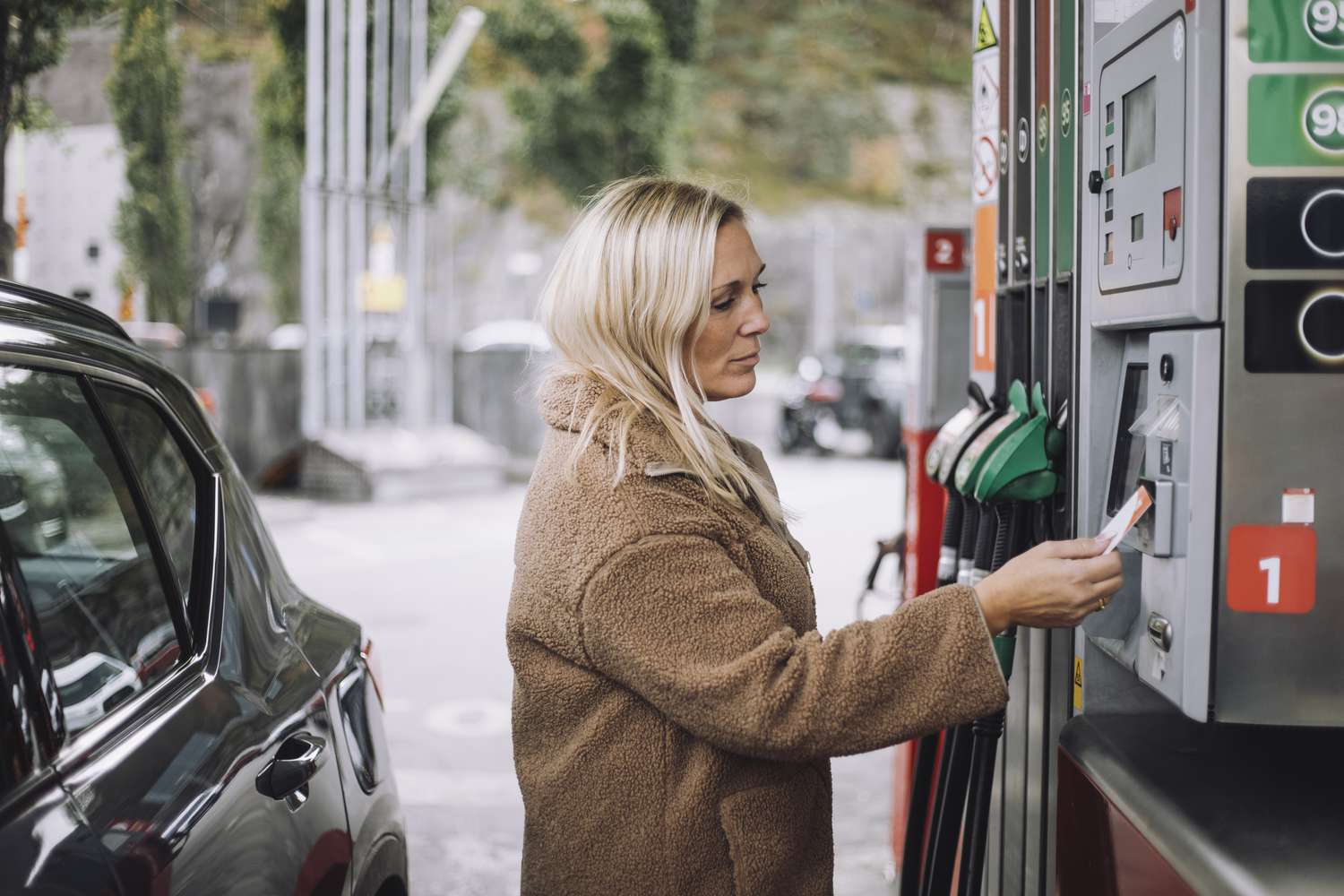A woman buys gas with a credit card