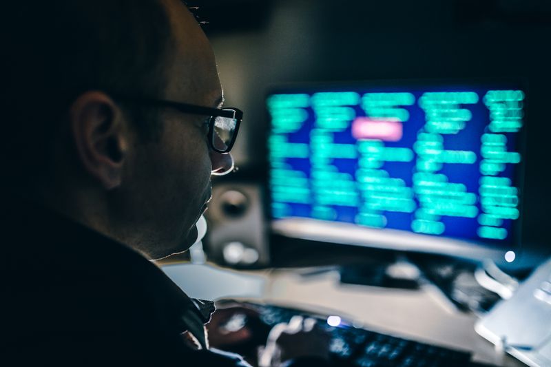 Computer hacker in front of computer.