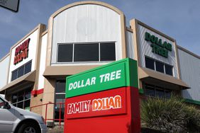 The green and red Dollar Tree and Family Dollar signs are seen in front of a building with a combined Dollar Tree and Family Dollar store.