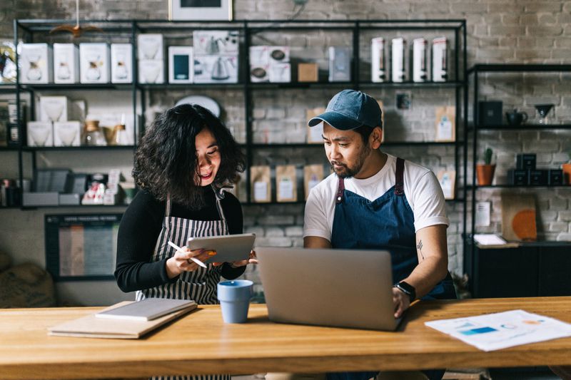 The owners of this coffee shop engage in a lively discussion, exchanging ideas and making plans for the business.