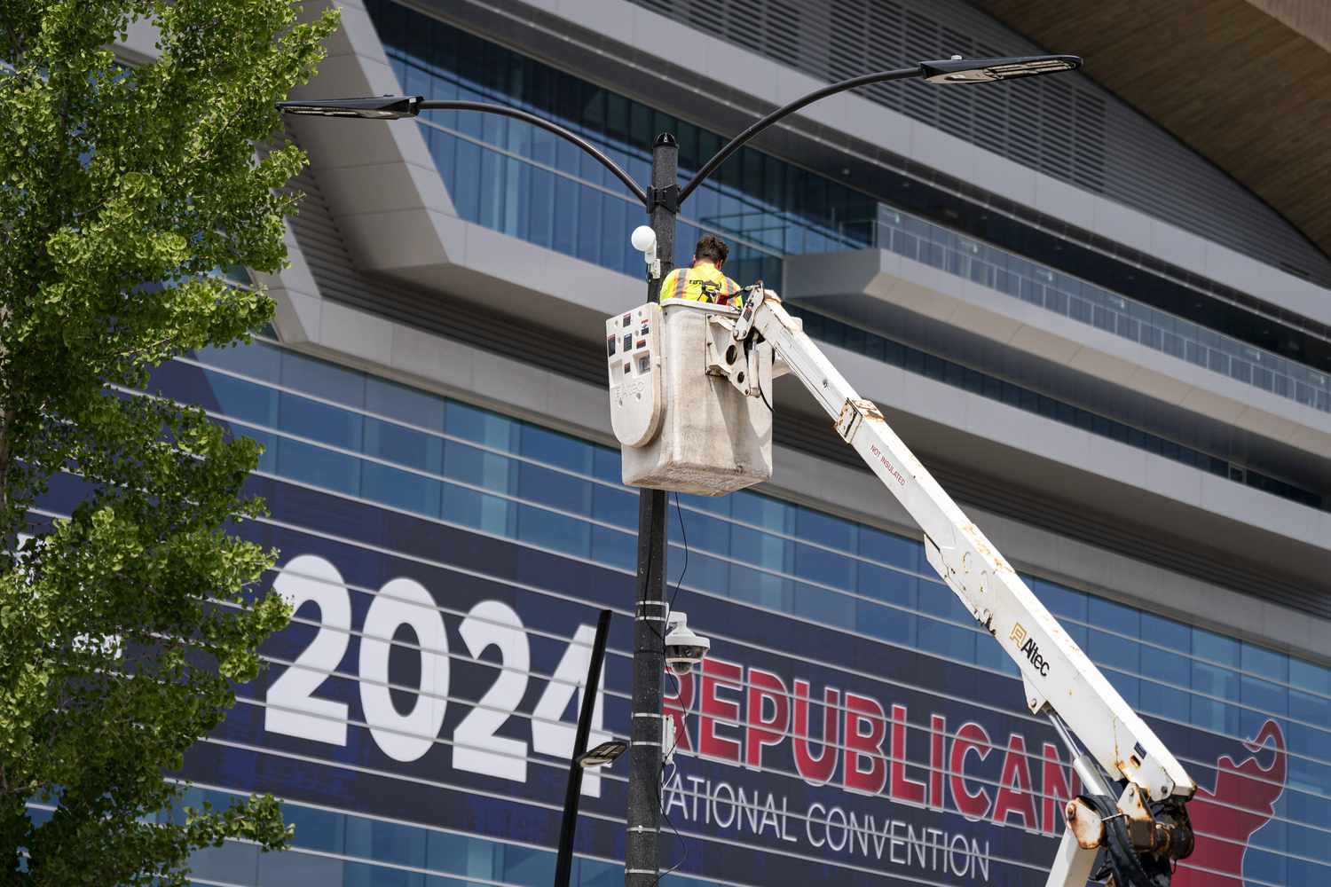 A worker installing a camera outside the Fiserv Forum ahead of the Republican National Convention in Milwaukee