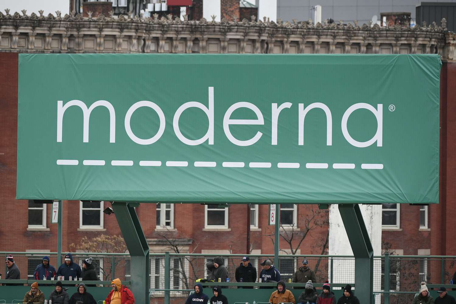 The Moderna logo is seen on a green sign at Fenway Park in Boston.