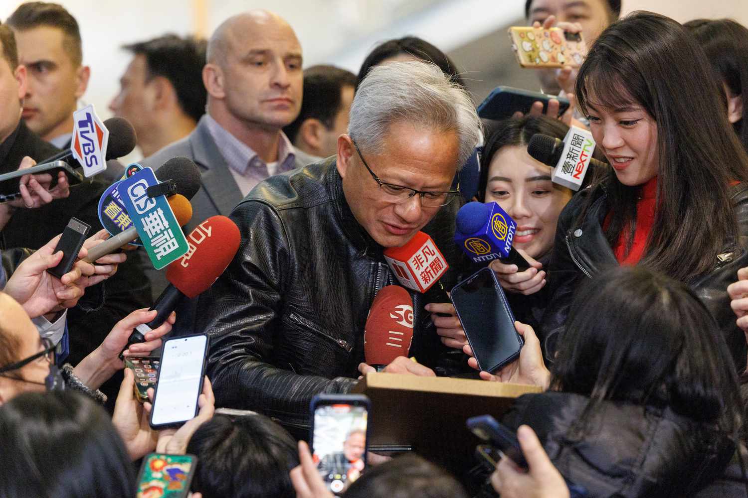 Nvidia co-founder and CEO Jensen Huang (C) arrives for Nvidia's end of year party in Taipei on January 17, 2025. 