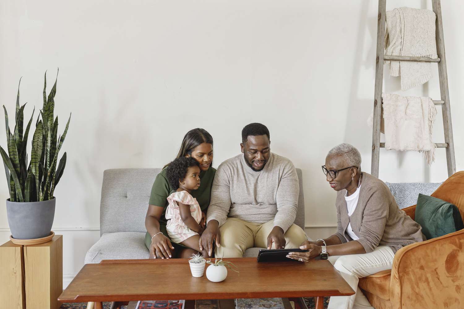 Financial advisor explaining paperwork to young couple with child