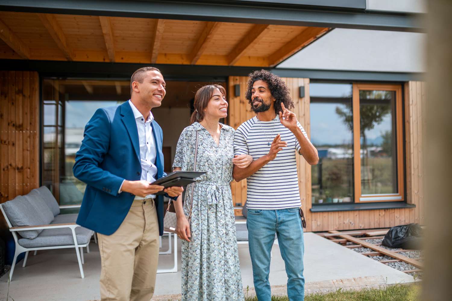 Cheerful interracial couple getting a mortgage to buy the house they're viewing as non-U.S. citizen. 