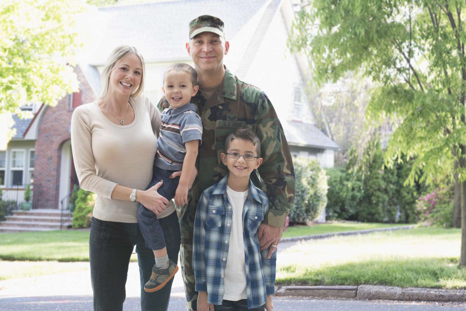 military family in front of house