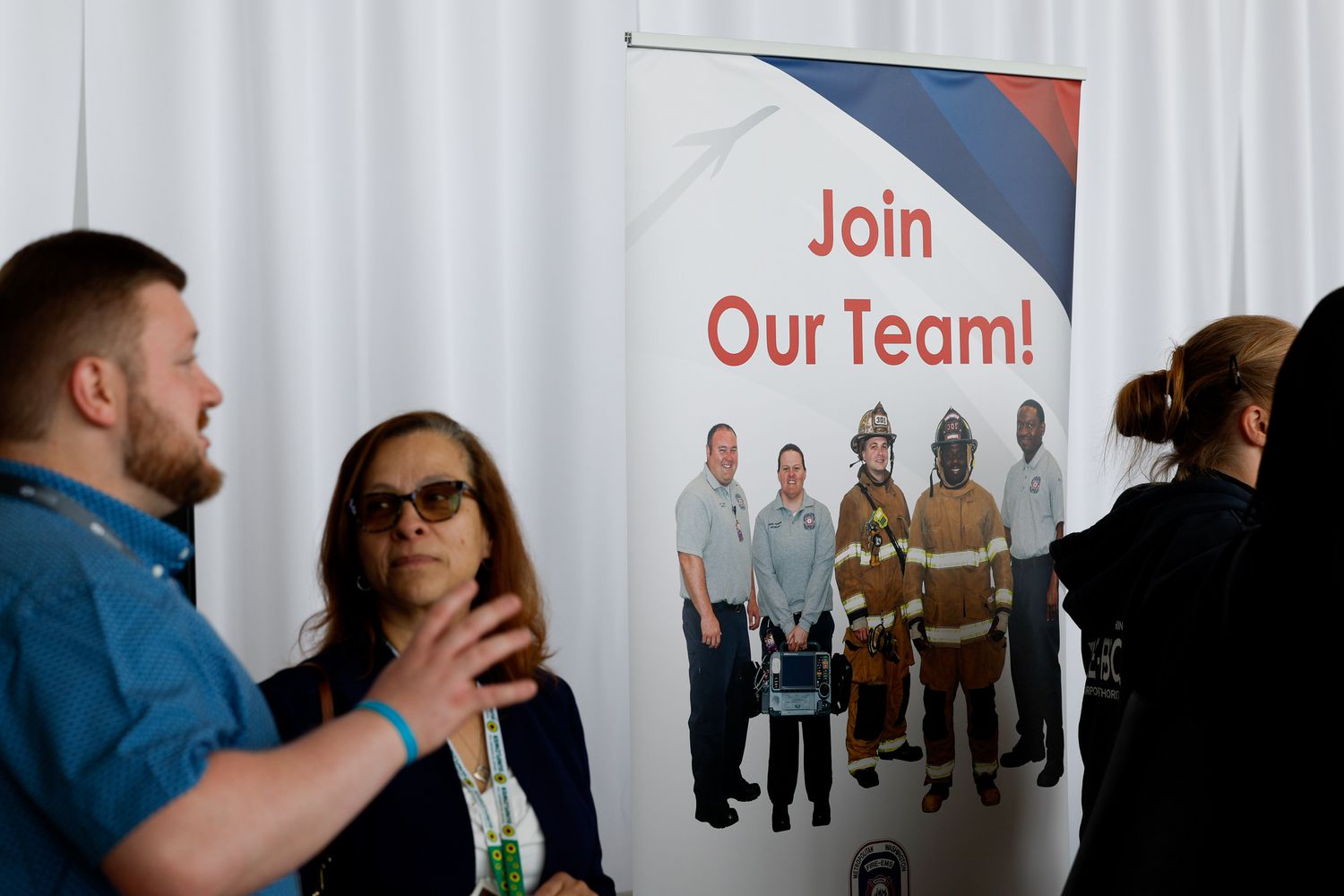 "Join Our Team" signage during a job fair hosted by the Metropolitan Washington Airports Authority to support federal workers looking for new career opportunities