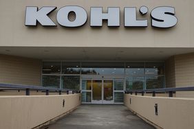 The white Kohl's logo is seen above the entrance to a store.