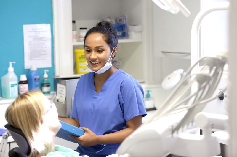 A dentist talks to a patient.