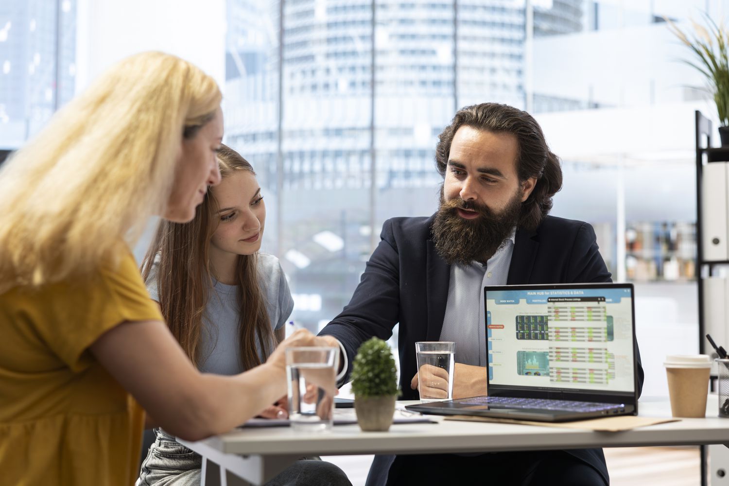 Financial advisor explaining a detail to two clients.