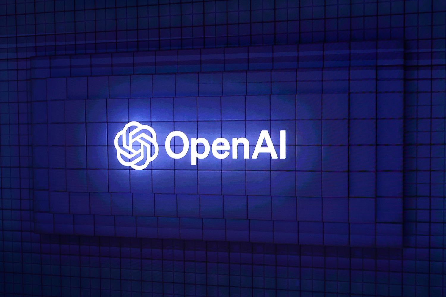 The OpenAI logo on display at a conference.