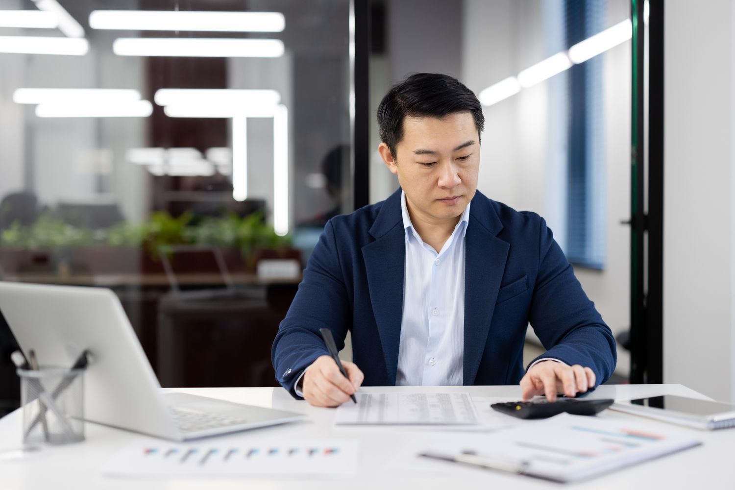 A businessman reviewing papers in an office
