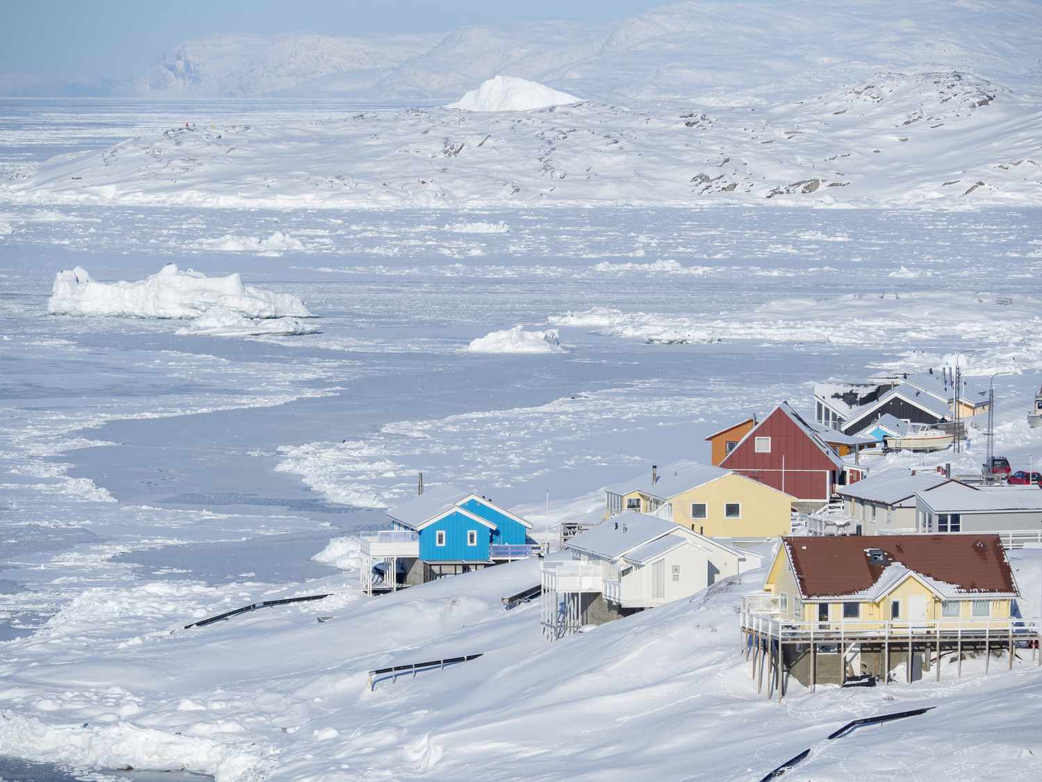 Disko Bay in Greenland showing some houses above the frozen waters
