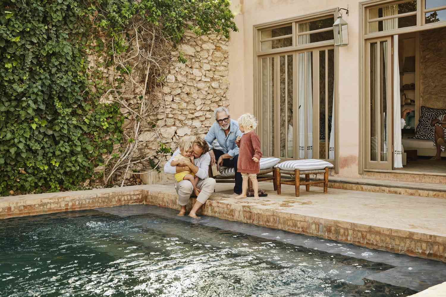 A multigenerational family next to a pool