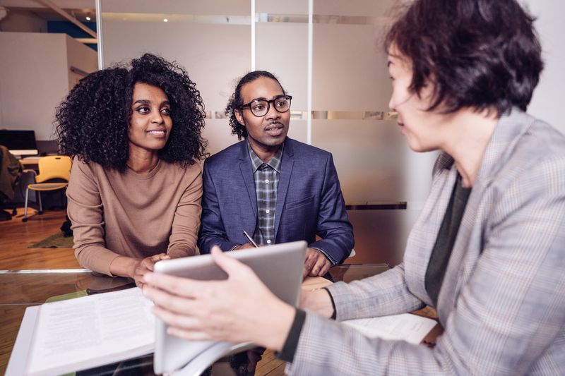 Financial advisor reviews investments with clients