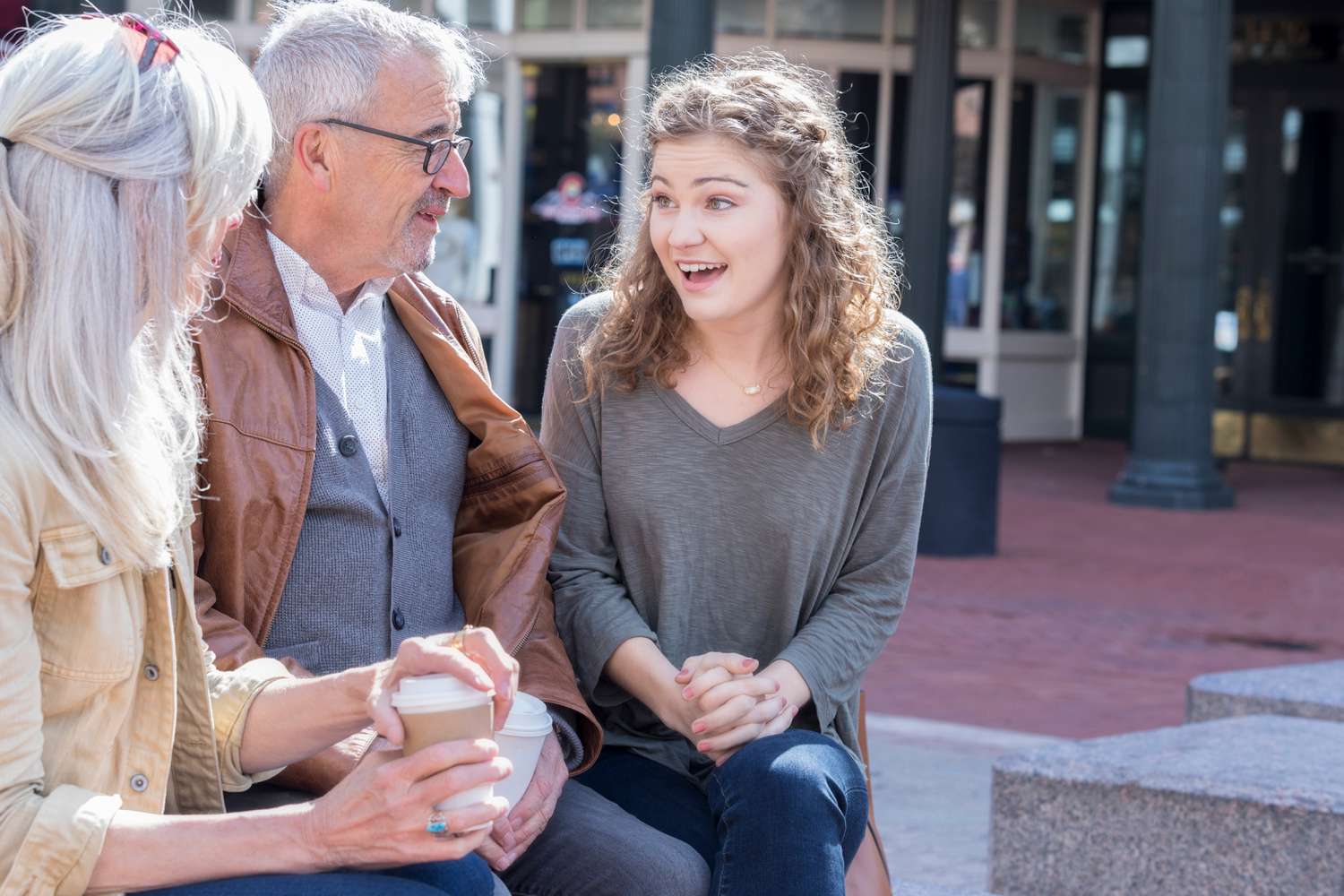 Young woman talks about her life and shares a story while her grandparents look at her and listen intently.