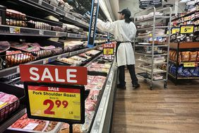 An employee restocks the shelves in the meat section of a supermarket in Monterey Park, California, on February 12, 2025. 