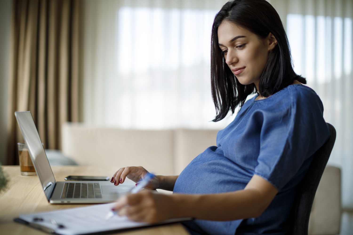 Pregnant woman working from home