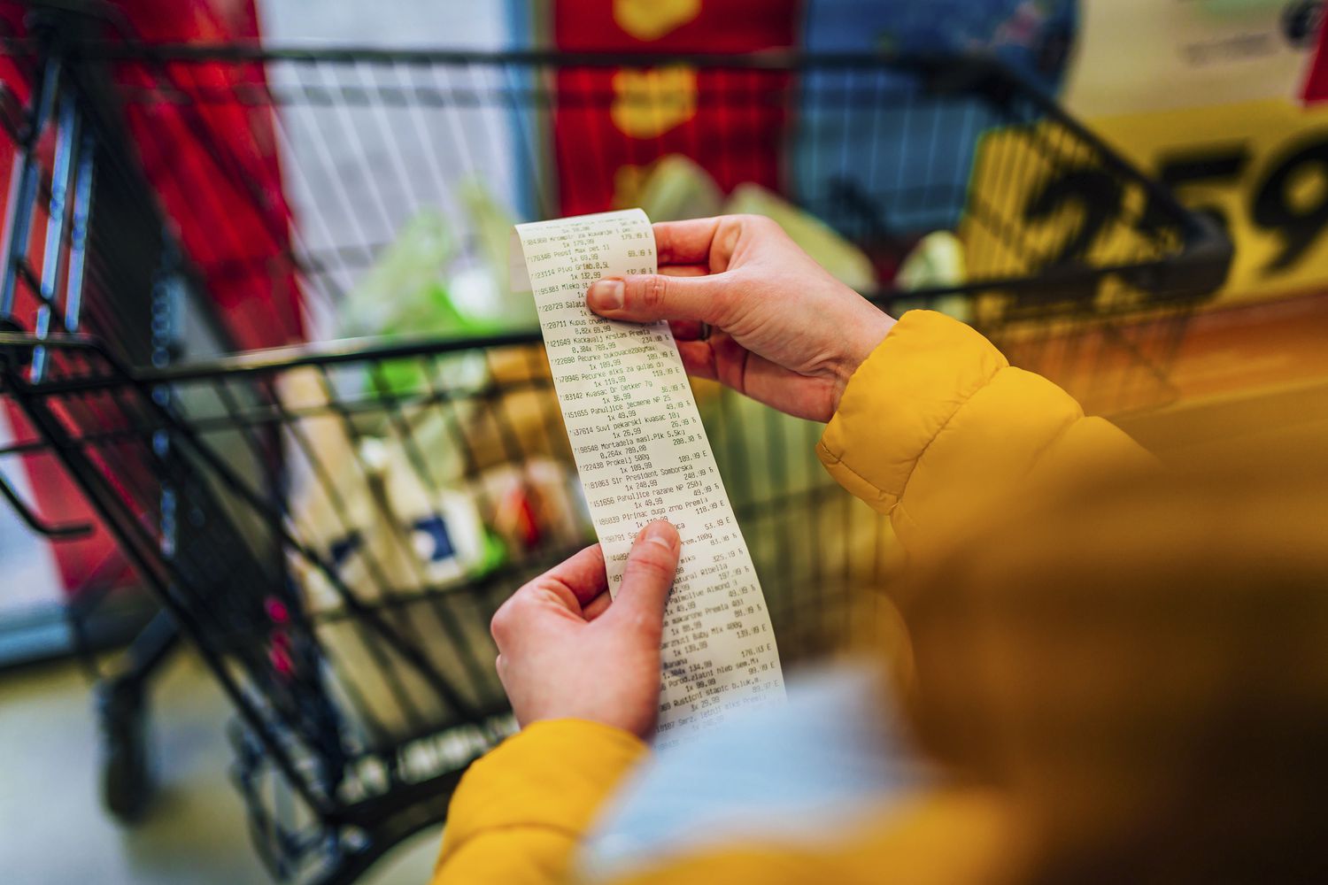 Woman checking bill at supermarket