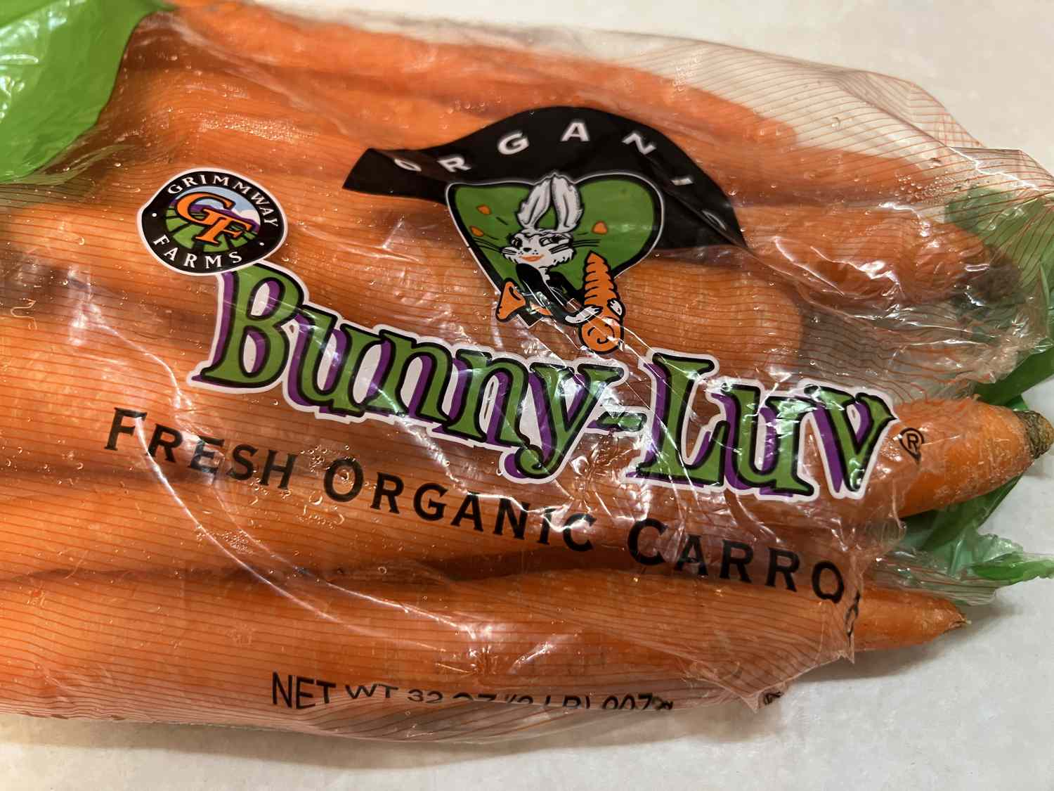A bag of Bunny-Luv Fresh Organic Carrots, made by Grimmway Farms, sits on a table