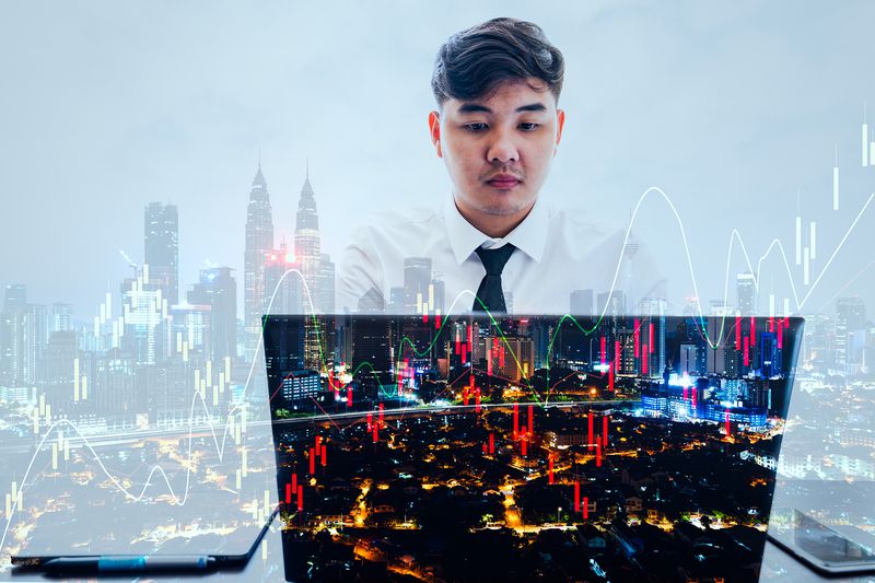 Business Man Hands Using Laptop With Abstract Business Chart