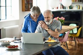 Older couple researching the best personal loans for fair credit on their laptop