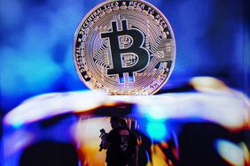 The Bitcoin symbol is seen on a blue background.