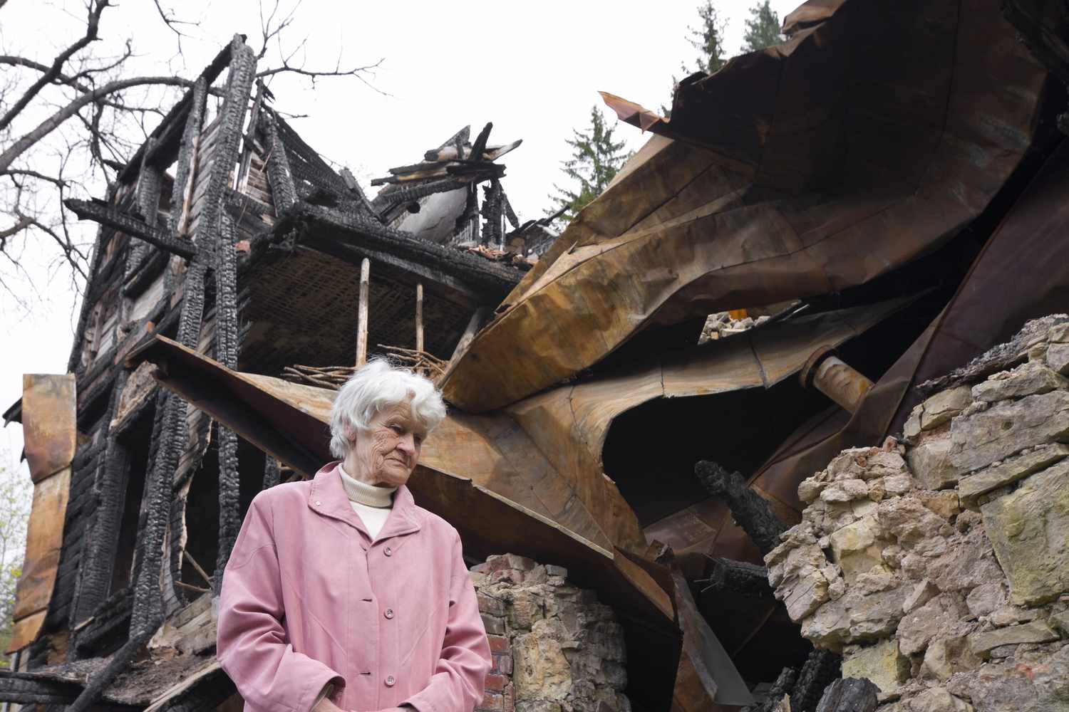 Woman with a reverse mortgage inspecting her home after a fire