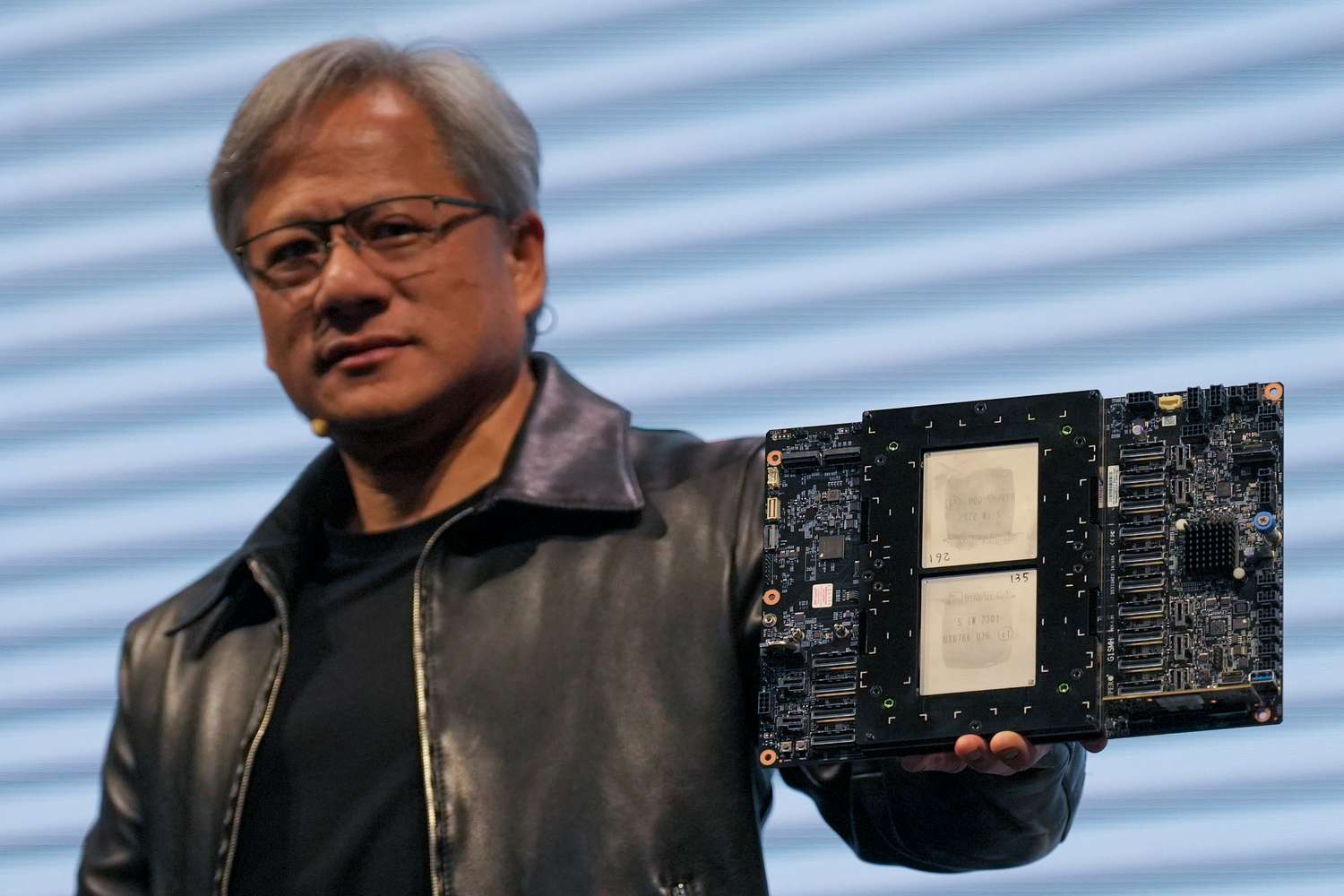 Jensen Huang, President of NVIDIA holding the Grace hopper superchip CPU used for generative AI at supermicro keynote presentation during the COMPUTEX 2023.