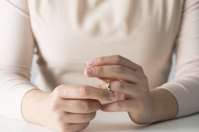 A woman taking off her wedding ring