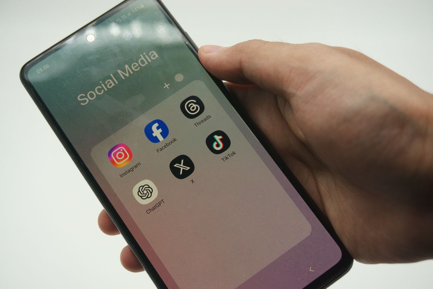 Person holding a mobile phone showing the tiktok app