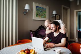 Couple looking at no-penalty CDs on their laptop