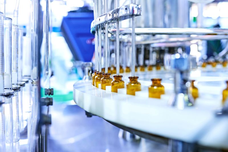 Brown medicinal bottles being filled on a production line